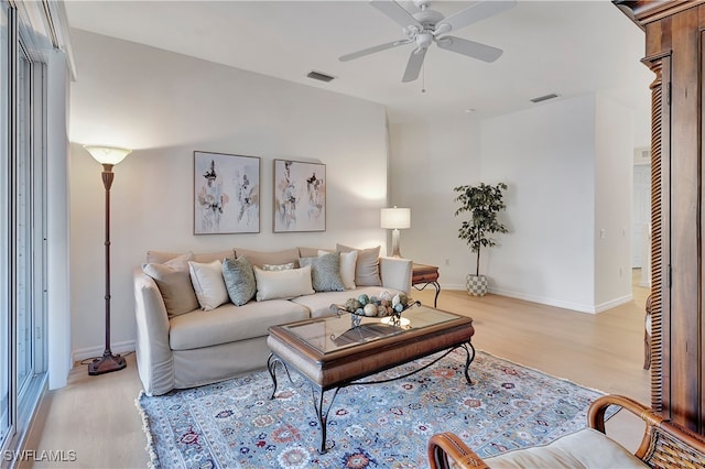 living room with light wood-type flooring and ceiling fan