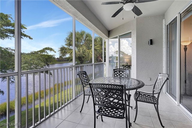 sunroom featuring a water view and ceiling fan