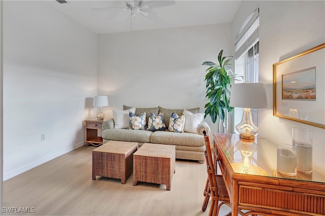 living room featuring ceiling fan and light hardwood / wood-style floors