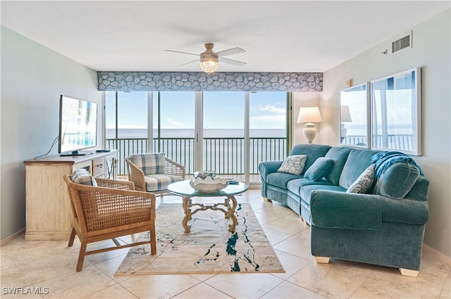 living room featuring light tile patterned flooring and ceiling fan