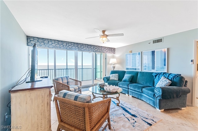 living room featuring ceiling fan and light tile patterned flooring