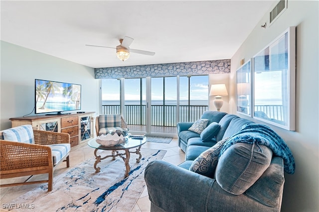 living room featuring ceiling fan and light tile patterned floors