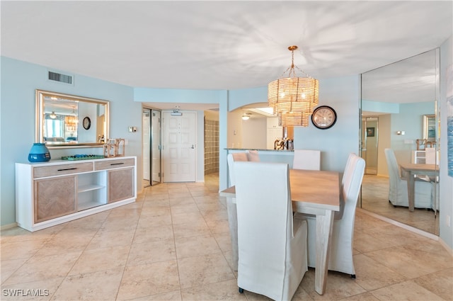 dining area featuring a notable chandelier and light tile patterned floors