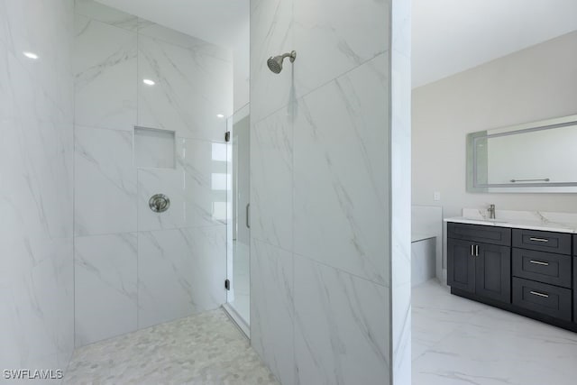 bathroom featuring vanity and tiled shower