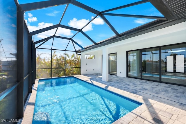 view of swimming pool with a patio and a lanai