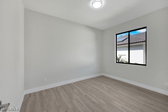 empty room with light hardwood / wood-style flooring