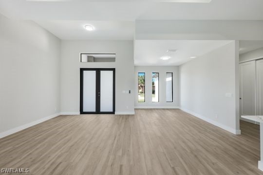 unfurnished room with light wood-type flooring