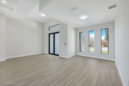 unfurnished room with light hardwood / wood-style floors