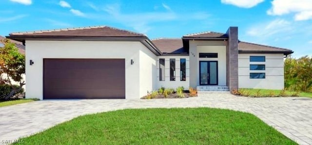 198 Gulfview Rd, Punta Gorda, FL 33950 - view of front of property with a garage, stucco siding, decorative driveway, and a chimney