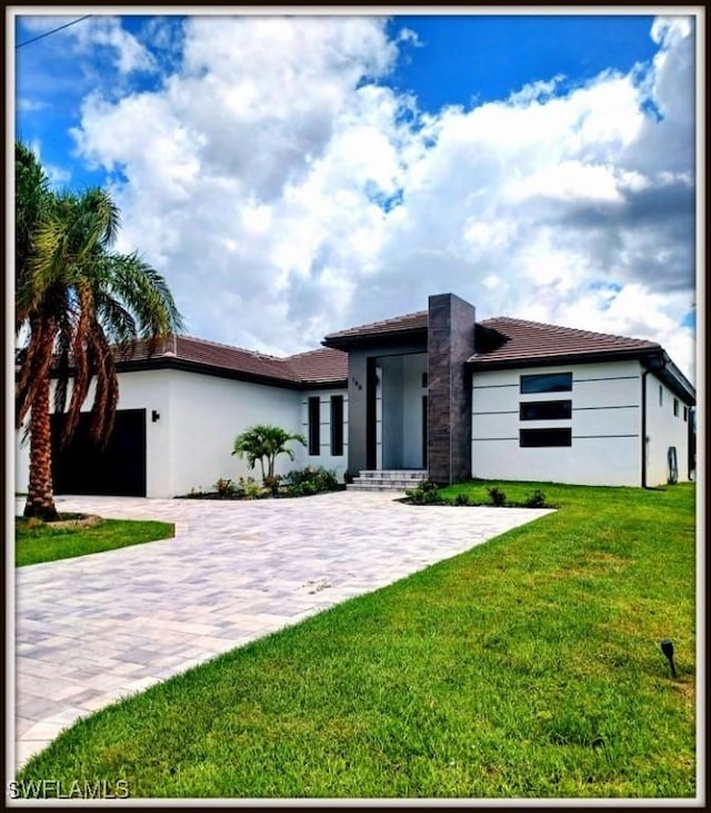 198 Gulfview Rd, Punta Gorda, FL 33950 - view of front of home with stucco siding, decorative driveway, a garage, and a front yard