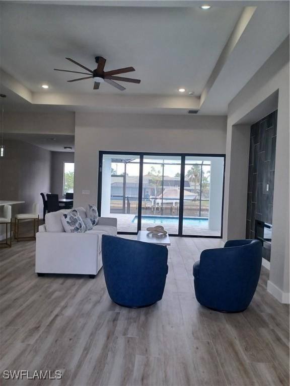 198 Gulfview Rd, Punta Gorda, FL 33950 - living room featuring a raised ceiling, wood finished floors, a ceiling fan, and recessed lighting