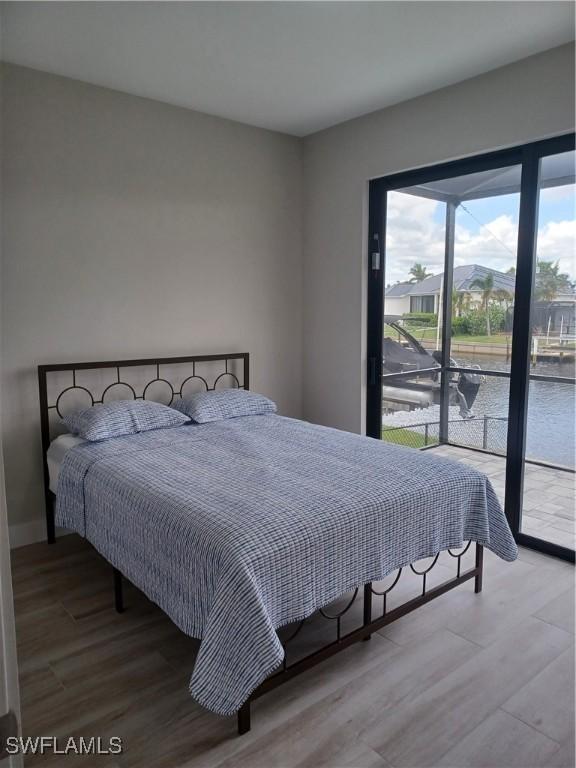 198 Gulfview Rd, Punta Gorda, FL 33950 - bedroom featuring access to exterior and wood finished floors