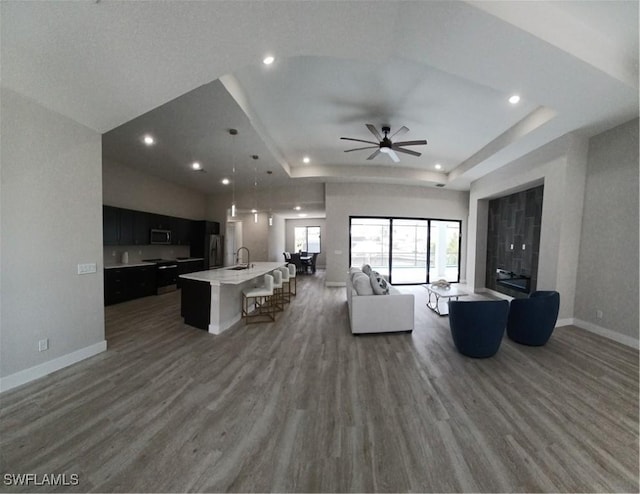198 Gulfview Rd, Punta Gorda, FL 33950 - living area with a tray ceiling, wood finished floors, ceiling fan, and recessed lighting