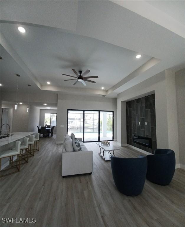 198 Gulfview Rd, Punta Gorda, FL 33950 - living room featuring a raised ceiling, wood finished floors, recessed lighting, and a ceiling fan