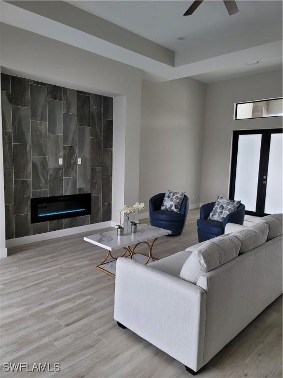 198 Gulfview Rd, Punta Gorda, FL 33950 - living area featuring wood finished floors, ceiling fan, and a tile fireplace