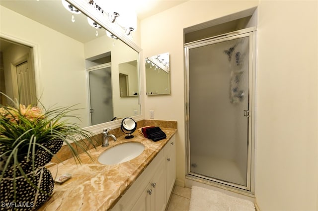 bathroom with vanity, tile patterned floors, and a shower with shower door