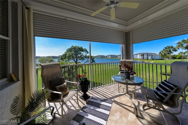 sunroom / solarium with ceiling fan and a water view