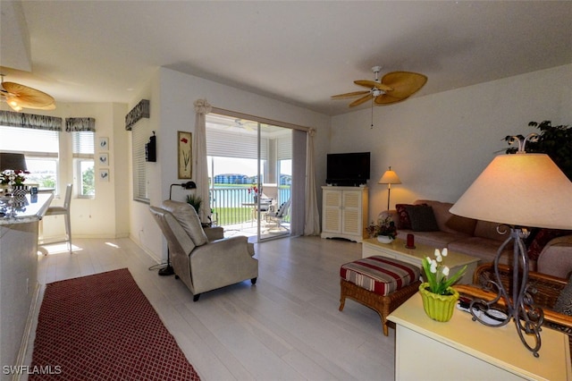 living room with light wood-type flooring and ceiling fan