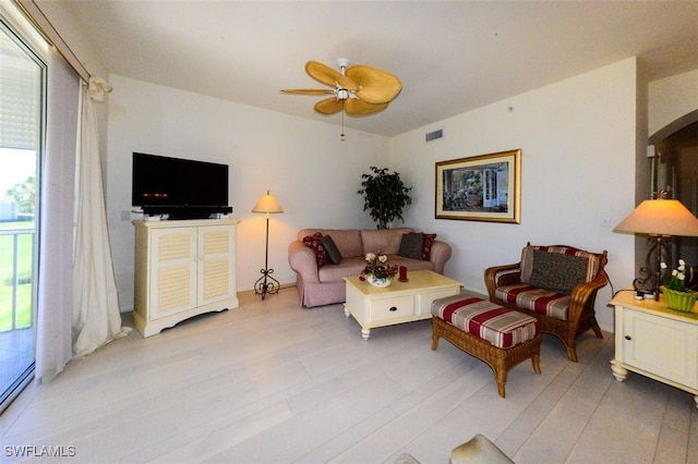 living room featuring light hardwood / wood-style floors and ceiling fan