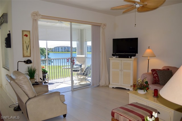 living room featuring ceiling fan and light hardwood / wood-style flooring