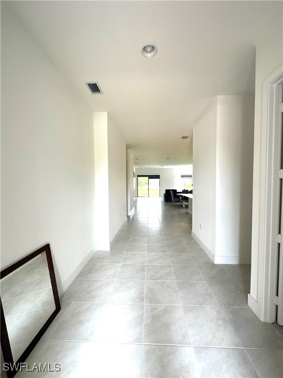 hallway with light tile patterned floors