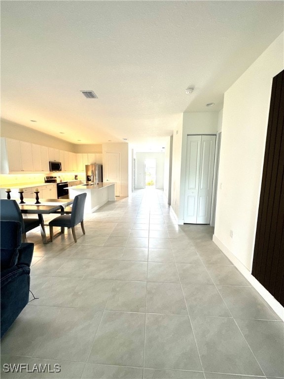 corridor with light tile patterned floors