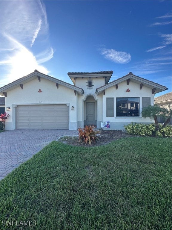 view of front of property with a front yard and a garage