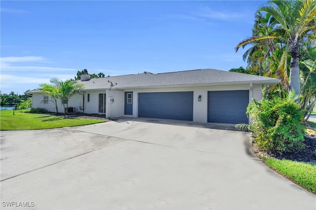 single story home featuring a garage and a front lawn