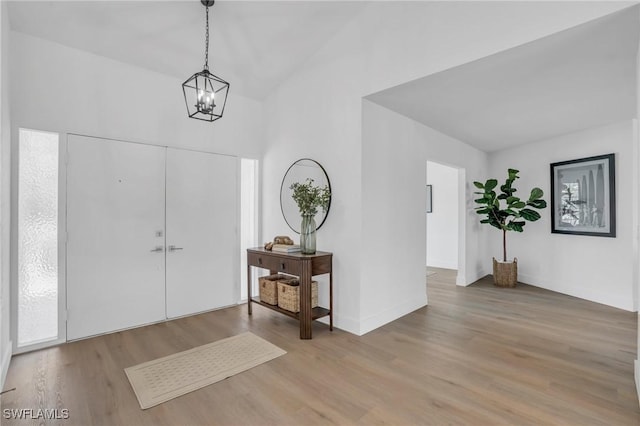 entrance foyer featuring a chandelier and light wood-style flooring