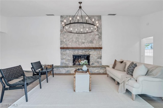 living room with a fireplace, visible vents, and wood finished floors