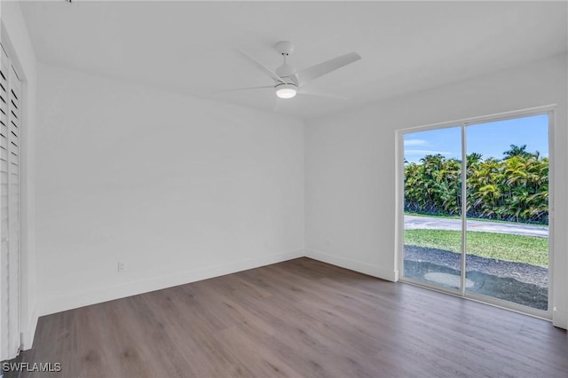 unfurnished room with ceiling fan, baseboards, and wood finished floors