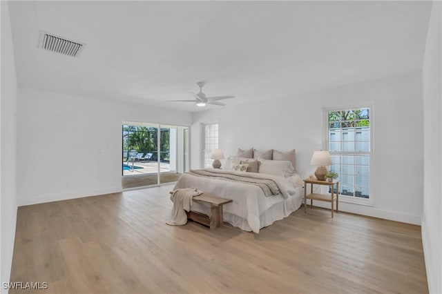 bedroom with access to exterior, visible vents, light wood-style flooring, ceiling fan, and baseboards