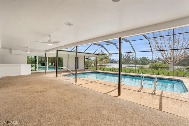 pool with a patio area, ceiling fan, and glass enclosure