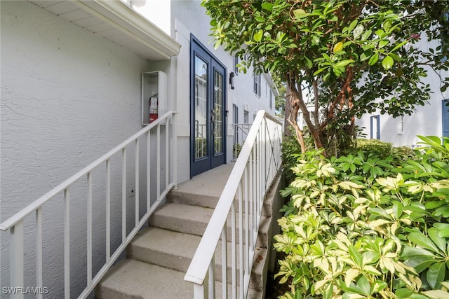 staircase with french doors