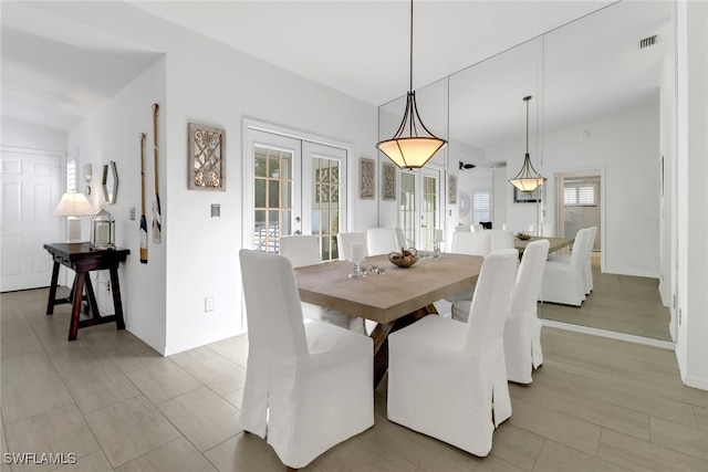 dining room with french doors and light hardwood / wood-style flooring