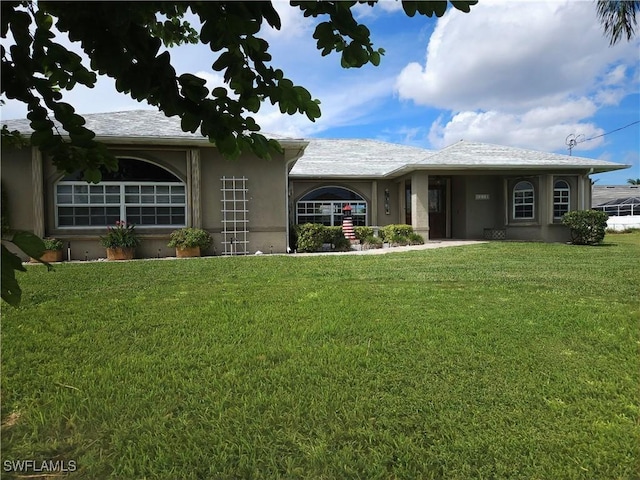 single story home featuring a front lawn and stucco siding