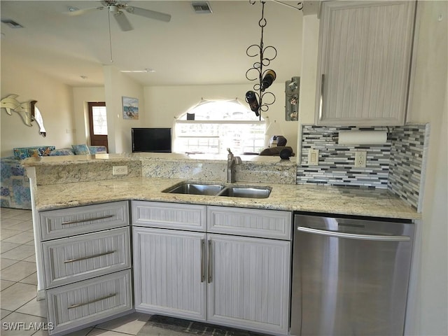 kitchen featuring visible vents, decorative light fixtures, a peninsula, stainless steel dishwasher, and a sink