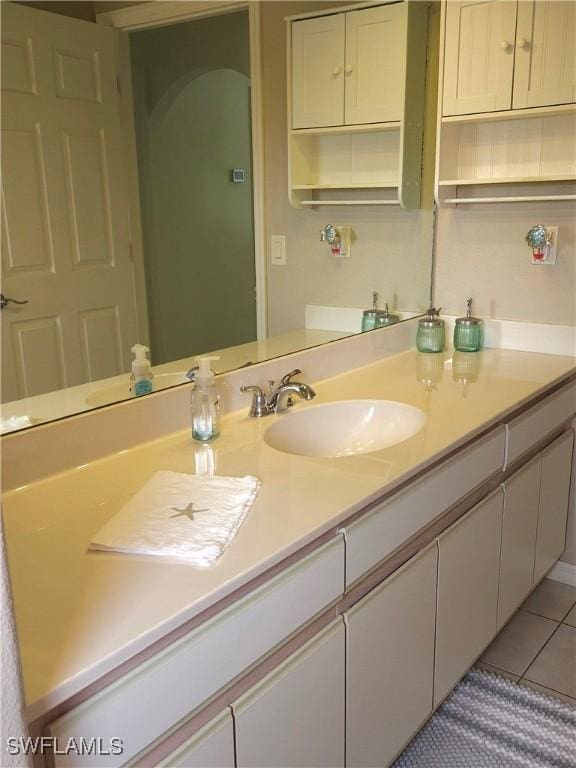 bathroom featuring tile patterned flooring and vanity