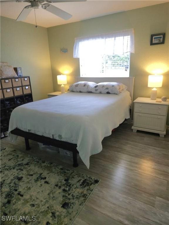 bedroom featuring dark wood-style floors and ceiling fan