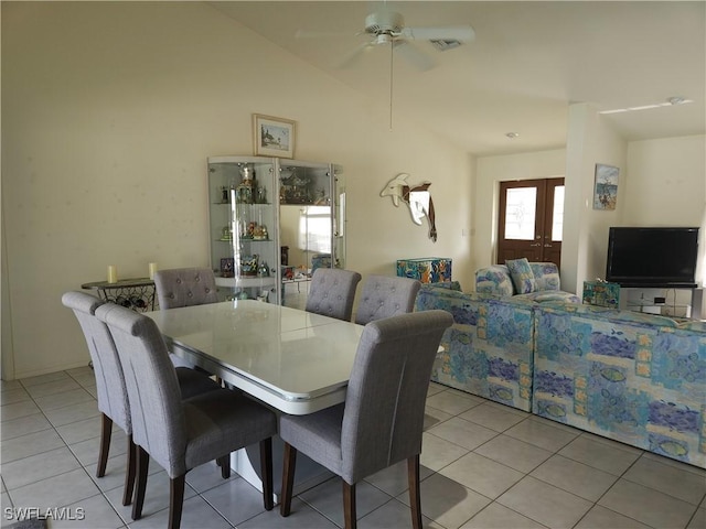 dining space featuring a ceiling fan, lofted ceiling, french doors, and light tile patterned floors