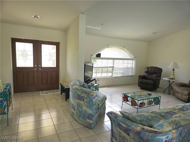 living area with light tile patterned floors and french doors