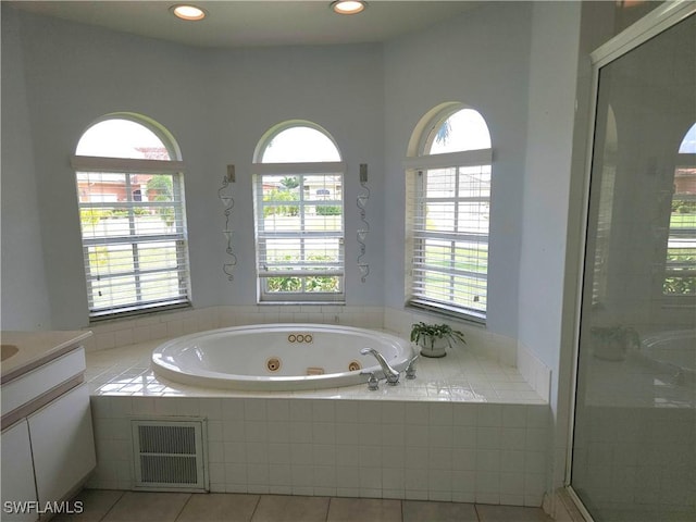 bathroom with visible vents, a stall shower, vanity, a tub with jets, and tile patterned floors