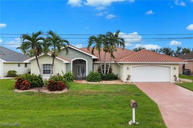 view of front of home with a front yard, a garage, and cooling unit