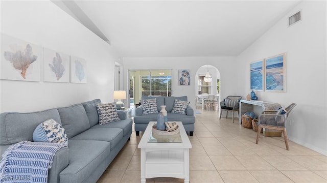 tiled living room featuring lofted ceiling