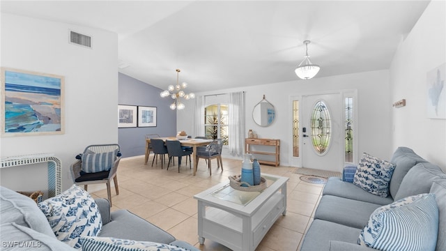 living room featuring a chandelier, light tile patterned floors, and vaulted ceiling