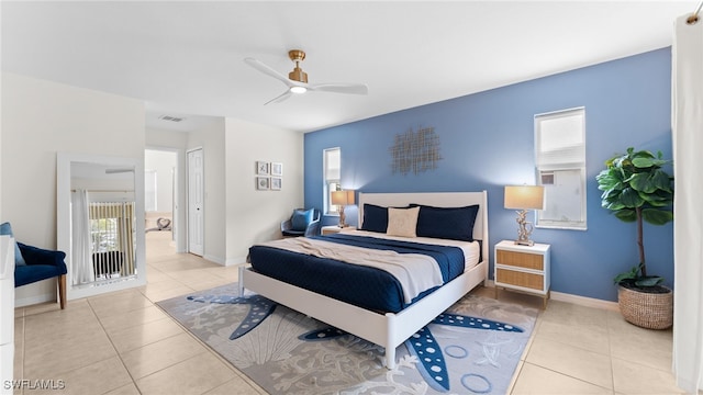 tiled bedroom featuring ceiling fan and a closet