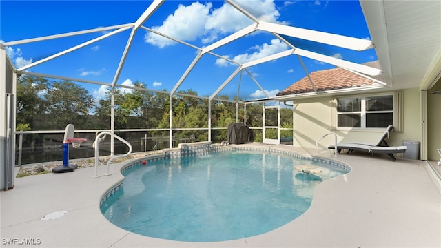 view of swimming pool featuring a lanai and a patio area