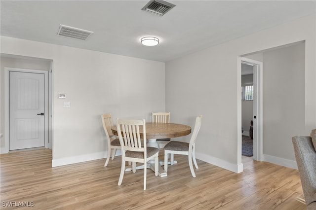 dining space with light hardwood / wood-style floors