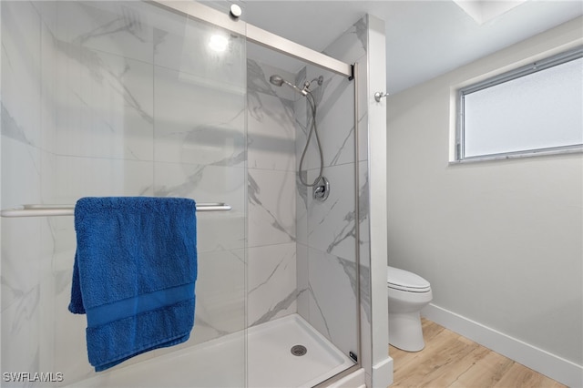 bathroom with walk in shower, hardwood / wood-style floors, and toilet