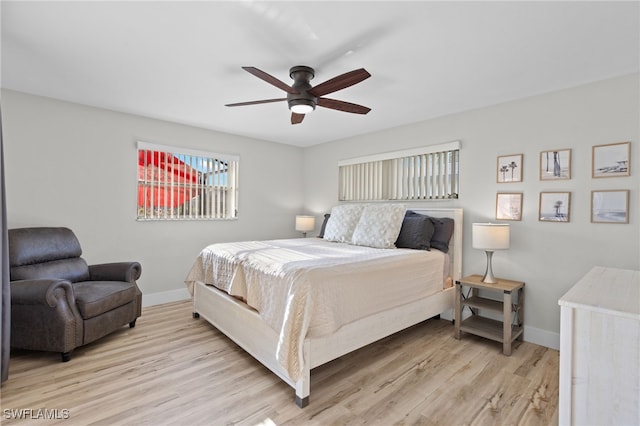 bedroom with ceiling fan and light hardwood / wood-style flooring